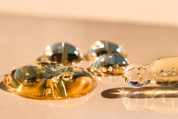 Gel texture beige color product with bubbles macro. Cosmetic gel for body and hair.