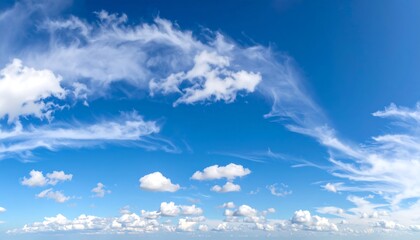 Wide shot of a vibrant blue sky with fluffy white clouds