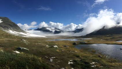 Obraz premium Serene Mountain Valley with Clouds and Lakes