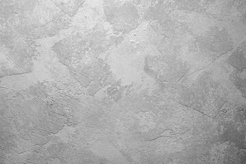 Gray textured plaster wall with abstract background