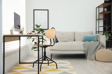 Stylish workplace with wooden desk, stationery and computer at home office. Interior design