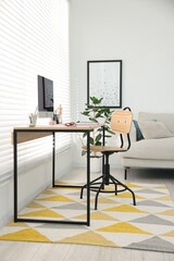 Stylish workplace with wooden desk, stationery and computer at home office. Interior design