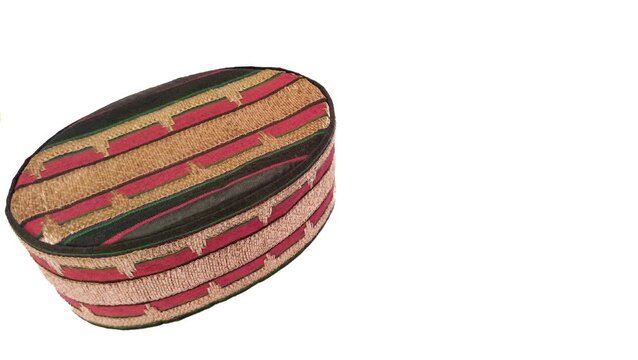 Traditional Lampung  cap made from  tapis fabric
with isolated white background, representing Indonesian heritage and culture.