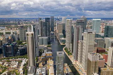 Naklejka premium Vertical cityscape showing Canary Wharf towers with Central London landmarks in the distance.