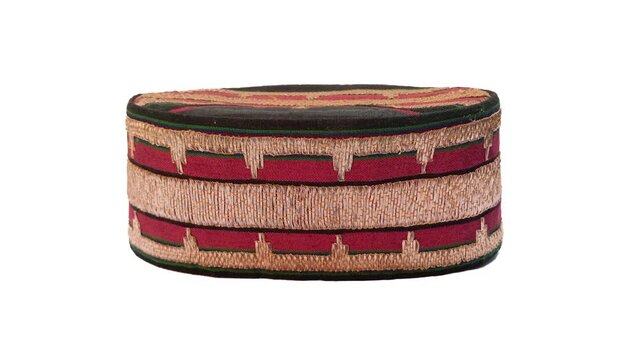 Traditional Lampung  cap made from  tapis fabric
with isolated white background, representing Indonesian heritage and culture.