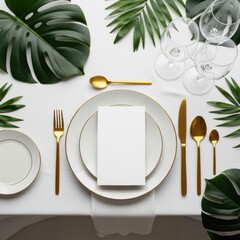 Tropical table setting with gold cutlery and wine glasses