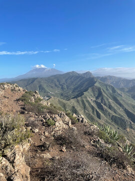 Natural Park in Tenerife with Lush Green Mountains and Distant View of Mount Teide &ndash; Scenic Landscape Capturing the Island&rsquo;s Wild Beauty and Volcanic Majesty under a Bright Sky