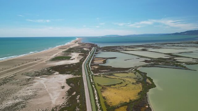 Aerial view of the Ebro Delta's unique landscape, where the river meets the sea, creating a tapestry of colors and textures, Ebro Delta, Catalonia, Spain.