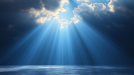 Sunbeams piercing dark clouds over calm sea