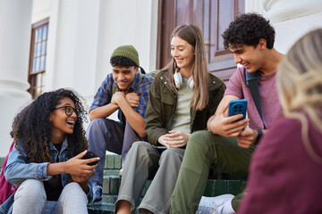 Happy smiling friends with phones laughing together