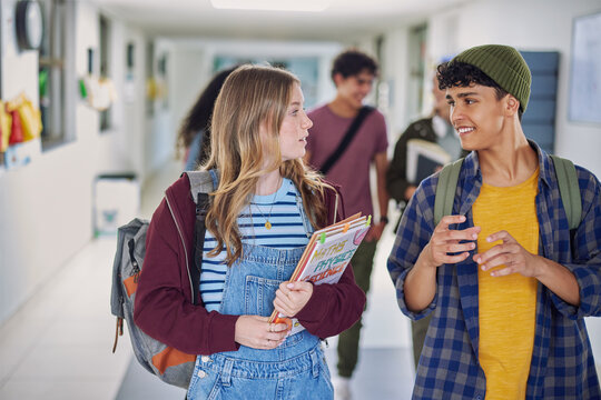Teen classmates talking in high school corridor - Powered by Adobe