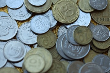 Metal coins of Ukraine of different denominations are scattered. Money texture, business background.