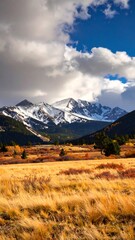 Fototapeta premium Autumnal mountain vista with snow-capped peaks (1)