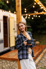 Young girl having coffee in her caravan