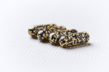 Iron capsules on bright background. Soft focus. Close up. Copy space.	