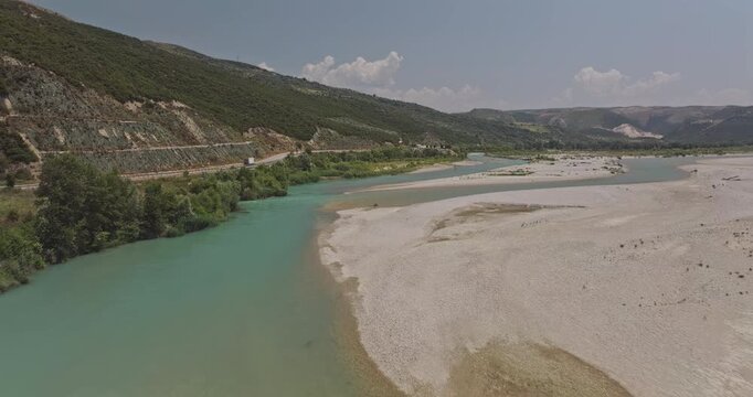 Vjosa River Albania Aerial v5 low flyover Vjosa River, winding through mountains with turquoise waters, white sands, and lush green banks under clear sky - Shot with Mavic 3 Pro Cine - July 12th 2024