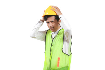 Construction worker wearing white shirt and green vest while wearing yellow hard hat isolated on white background