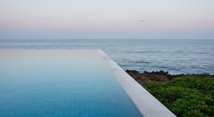 Infinity Pool Overlooking Serene Ocean at Dusk