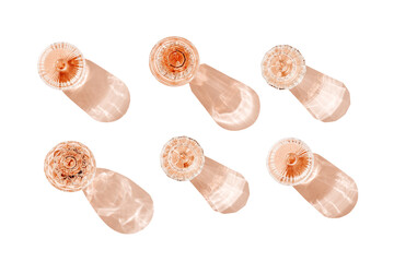 Set glasses of rose wine isolated on white background with shadows from sunlight. Top view wineglass cutout objects for design, sparkling alcohol drink above view with caustics effect from dark light