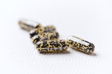 Iron capsules on bright background. Soft focus. Close up. Copy space.