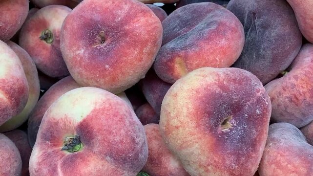 Flat peaches creating a vibrant textured background for summer and healthy eating themes