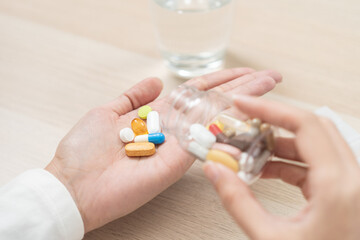 Healthcare Harmony: Close-Up Hands Holding Medication and Water Glass for Optimal Wellness, Pharmaceutical Treatment and mental health treatment