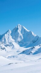 Naklejka premium A beautiful and majestic mountain peak covered in pristine white snow under a clear and vibrant blue sky, creating a stunning winter landscape.