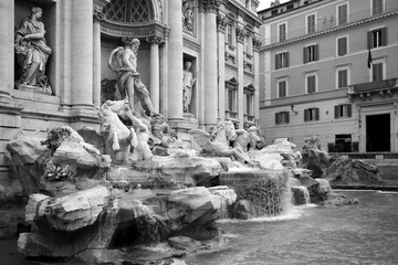 Detailed black and white view of Fontana di Trevi in Rome with statues, cascading water and baroque details, revealing dynamic movement and historical drama in architectural design.
