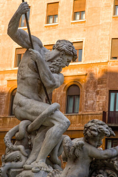 Baroque statue of Neptune with trident in Piazza Navona, Rome, captured from low angle with intense daylight, blending mythological narrative and strong vertical expression.