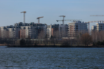 Naklejka premium Construction of buildings and high-rise cranes against the sky