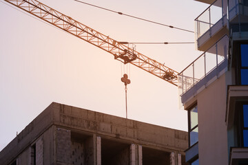 Construction of buildings and high-rise cranes against the sky