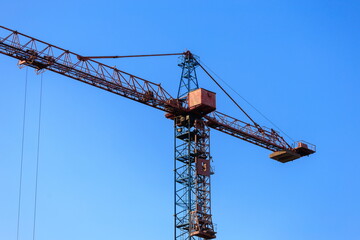 Construction of buildings and high-rise cranes against the sky