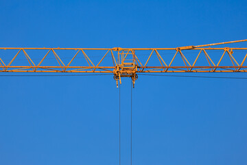 Construction of buildings and high-rise cranes against the blue sky