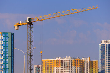 Construction of buildings and high-rise cranes against the sky