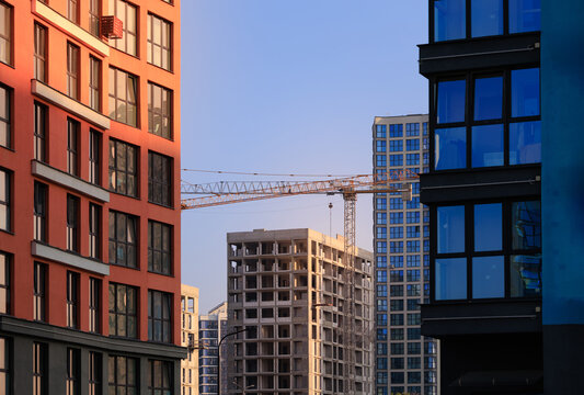 Construction of buildings and high-rise cranes against the sky