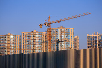 Naklejka premium Construction of buildings and high-rise cranes against the sky