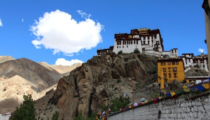Monastery nestled on a rocky hill under a clear blue sky