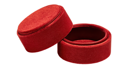 Two circular, red velvet jewelry boxes opened, resting on a black background.  The boxes are round, with a slightly domed top, and made of a plush, textured velvet