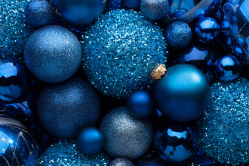 Christmas Holiday background with blue baubles, ornaments.
 Close up of pile blue  Christmas balls,various size. Flat lay