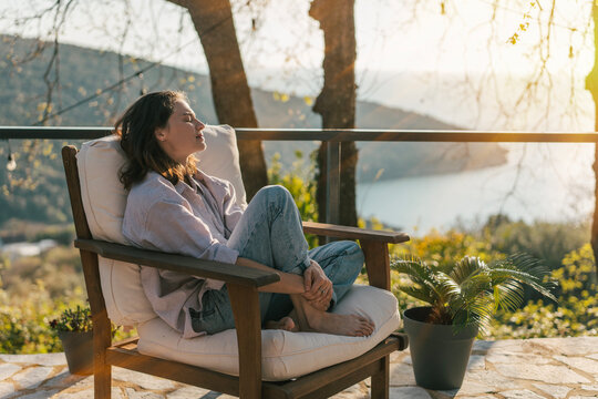 Young woman enjoying nature view from terrace