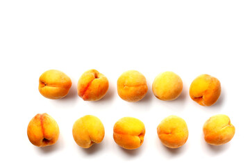 Fresh ripe apricots on a white background.