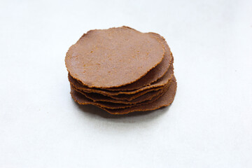 Sun-dried fermented soybean sheets called “Thua Nao,” a traditional ingredient in Northern Thai cooking.