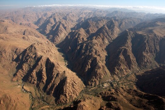 High-angle view of a rugged mountain valley, with canyons and peaks - Powered by Adobe