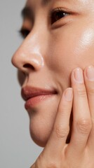 A woman's hand gently touches her face