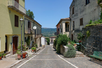 Fototapeta premium A narrow street among the old houses of Cantalupo del Sannio, a small town in Molise, Italy.