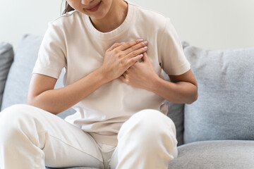 Obraz premium Close-up woman touching chest feeling pain heart attack symptom