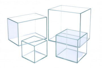 Four clear glass cubes and rectangular prisms arranged in a geometric composition, showcasing transparency and modern design.