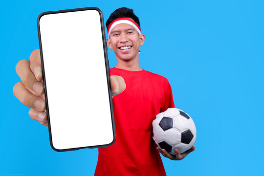 Cheerful Asian Male Wear Headband Presenting Mobile Phone With Blank Screen For Mockup