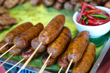 Sai krok Isan is a fermented grilled pork sausage originating from the Lao, A popular street food snack found in traditional night markets in Bangkok, Thailand