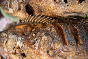 Close-up detail of grilled fish, a popular Thai dish being sold in a street food market in Chinatown, Bangkok.